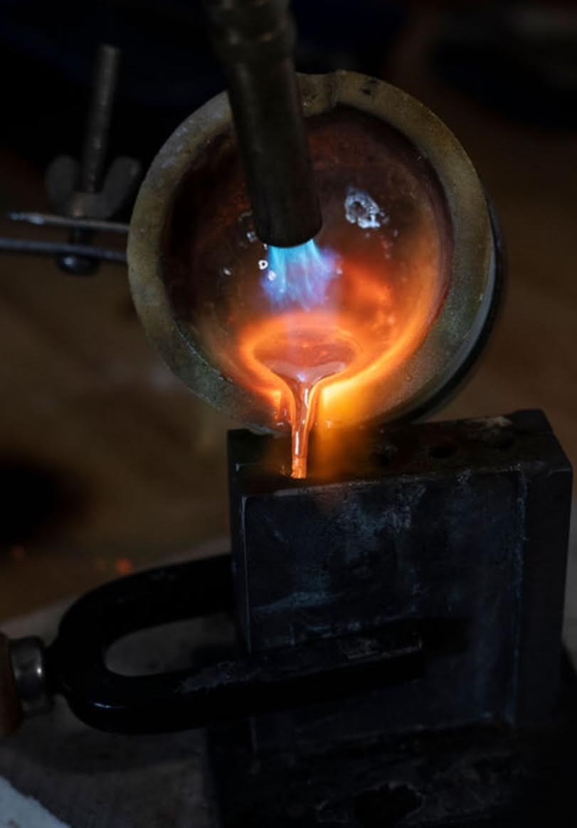 Molten sterling silver being poured into an ingot mold at the L3 Designs bench