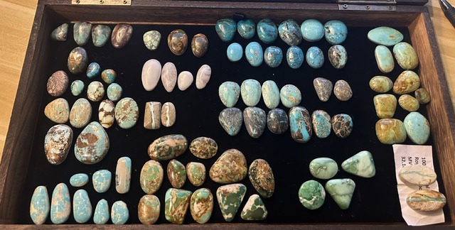 L3 Designs working stone library — over 80 hand-cut turquoise cabochons sorted on black velvet